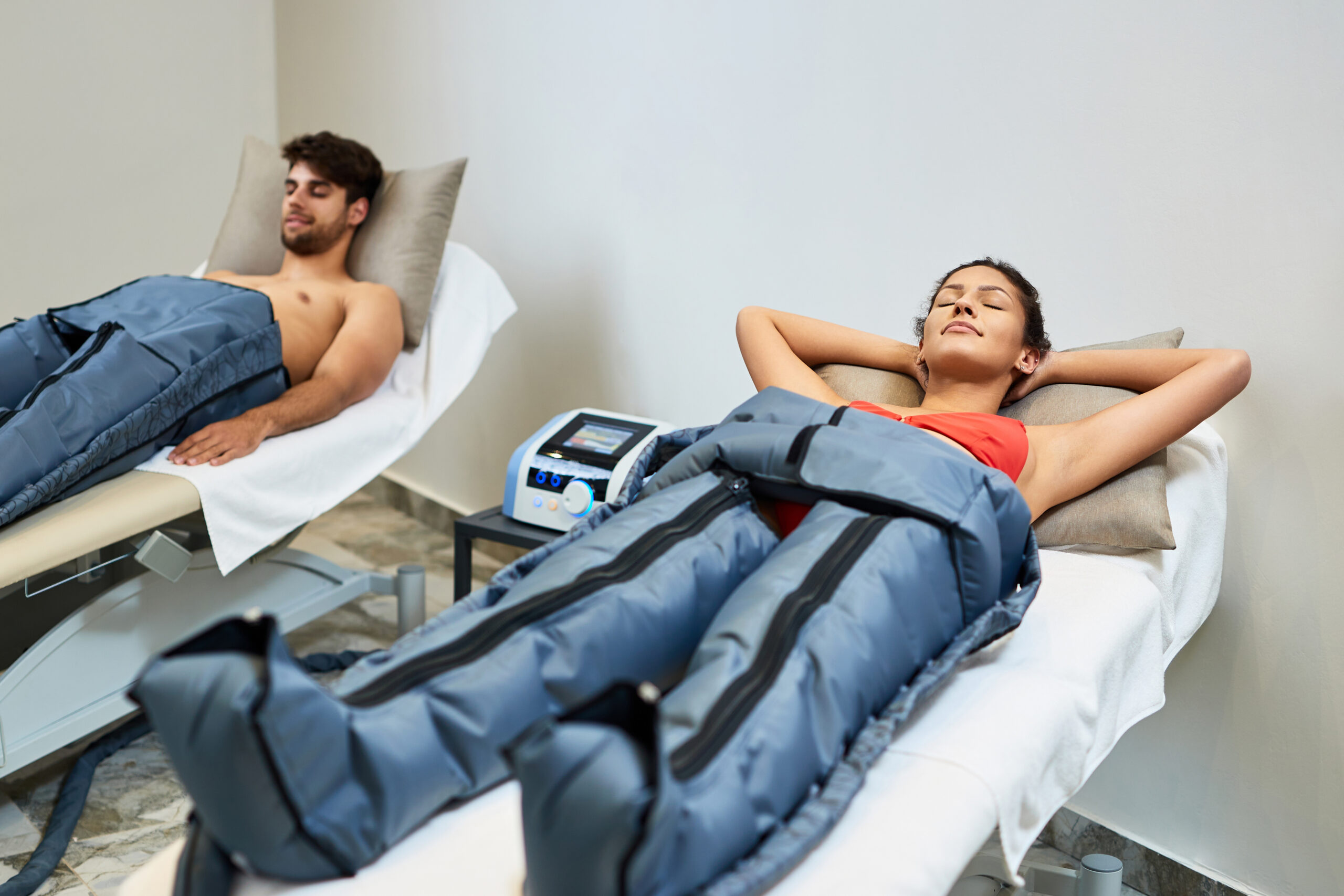 relaxed woman her boyfriend enjoying pressotherapy wellness center scaled